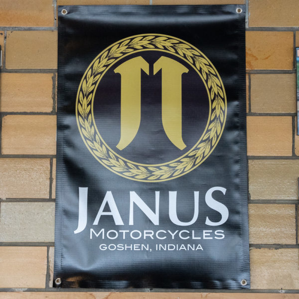 Janus Motorcycles banner with logo on a brick wall in Goshen, Indiana.