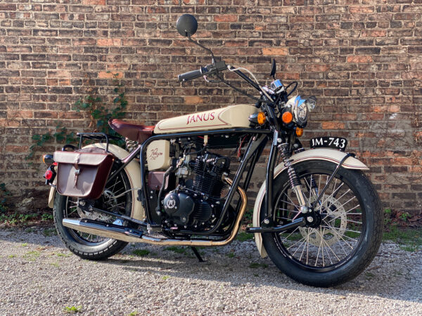 Vintage Janus Halcyon 250 motorcycle parked by a brick wall.