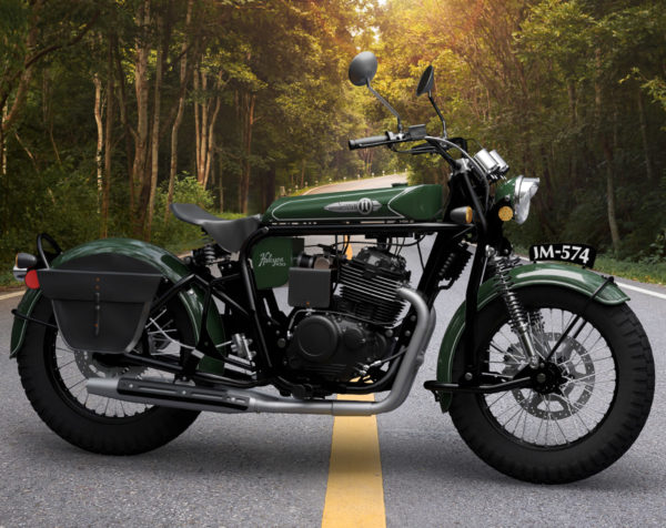 Classic green motorcycle parked on a forest roadside.