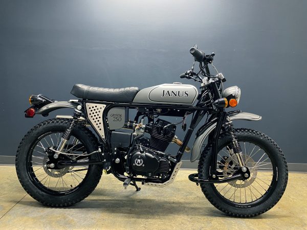 Classic Janus motorcycle with gray tank and black seat on display.