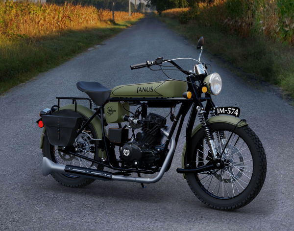 Vintage-style Janus motorcycle parked on a country road near cornfields.