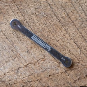 4mm-5mm double-ended wrench on a wooden background.